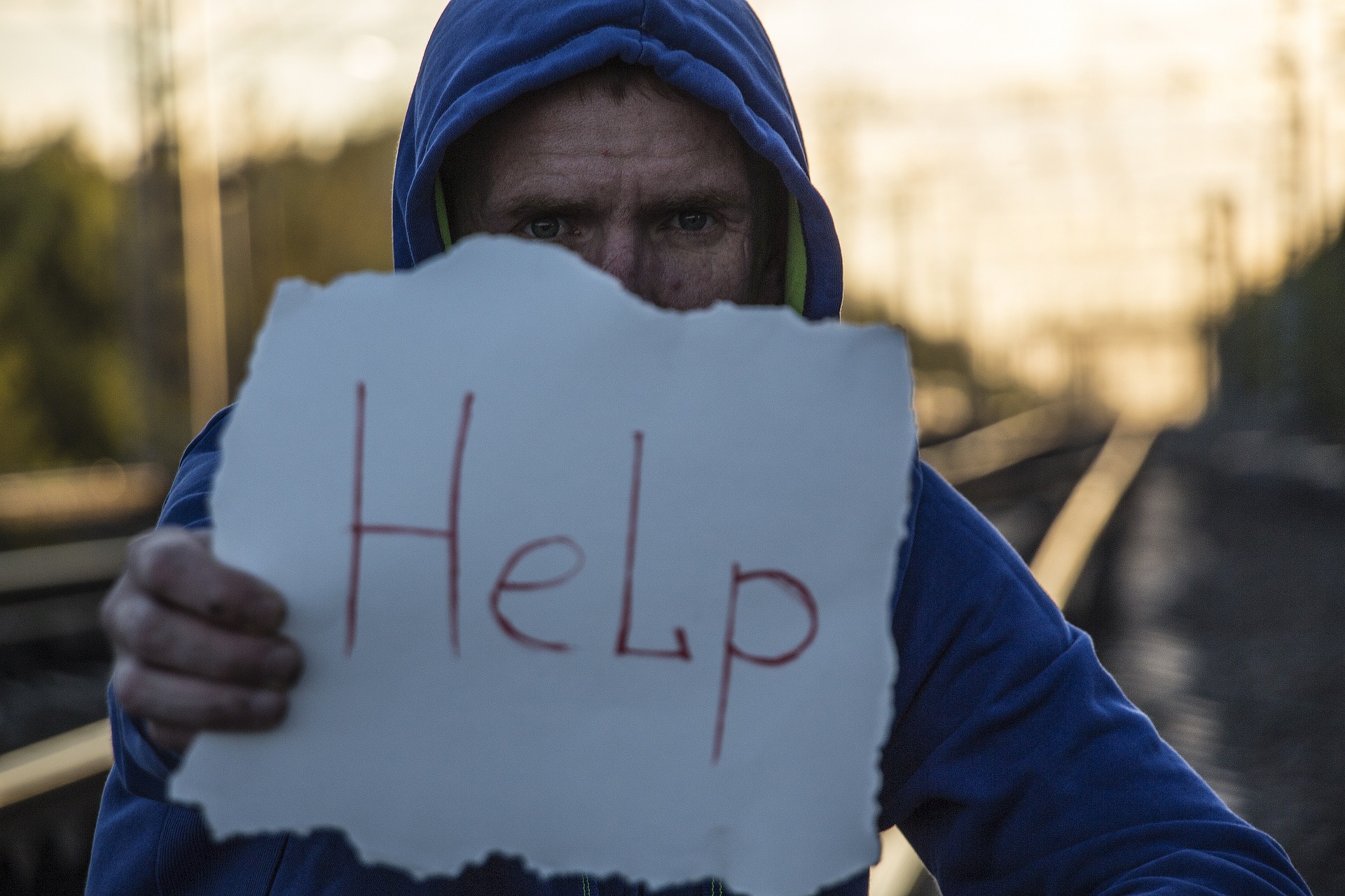 person holding help sign